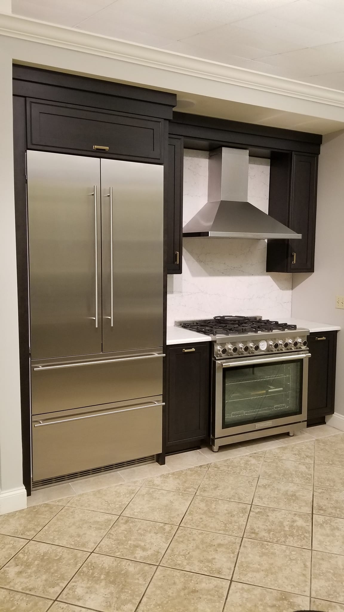 Liebherr Refrigerator, Zephyr Hood and Superiore Range with dark cabinets and white countertop | Marchand Creative Kitchens Cabinets New Orleans Metairie Mandeville LA